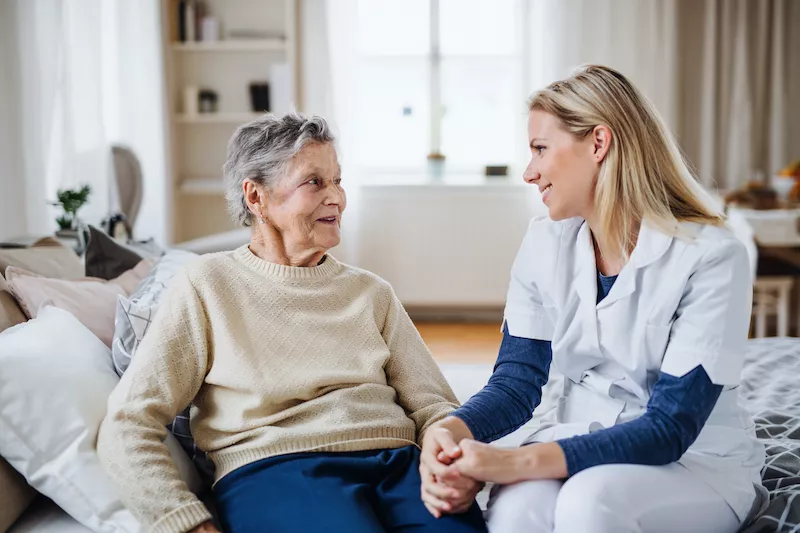 live in caregiver in discussion with an elderly woman she is caring for.